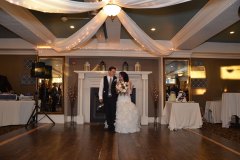 Bride-and-groom-walking-in-recption-room-together