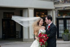 Bridge-with-red-bouquet-with-groom-outside-of-Niagara-Crossing-Hotel-and-Spa