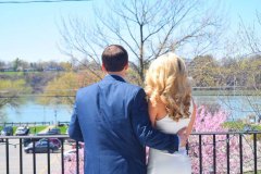 Man-and-woman-looking-out-a-the-water-outdoors
