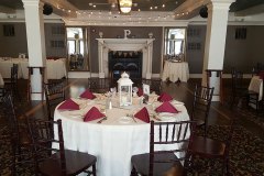 Wedding-table-setting-with-red-napkins-and-string-lights-above