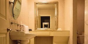 guest bathroom with vanity, mirror, and sink