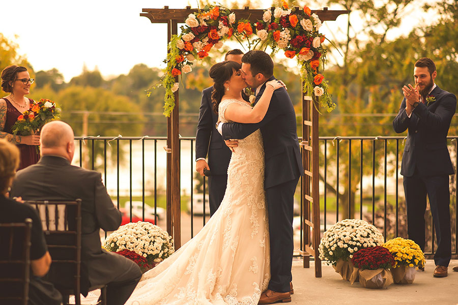 bride and groom kissing at the altar