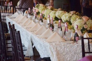 table setting with pink champagne bottles and napkins